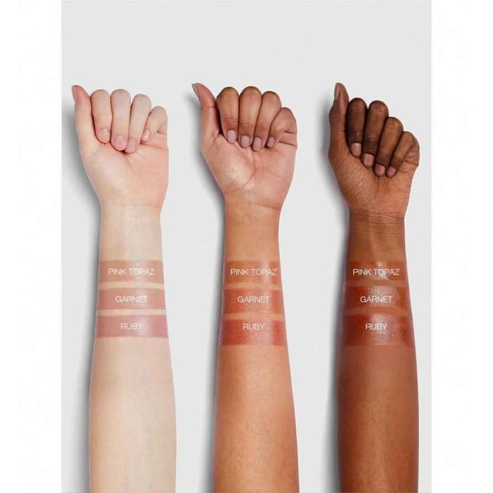 Close up of Ruby lip balm soft glossy texture on hand or lips deep red with warm fruity undertone hydrating gentle gel texture natural shiny finish without stickiness Sheglam