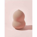 Extreme close up of single blender pink from Sheglam 6 piece set very soft porous flexible sponge texture for optimal foundation absorption velvety surface Sheglam