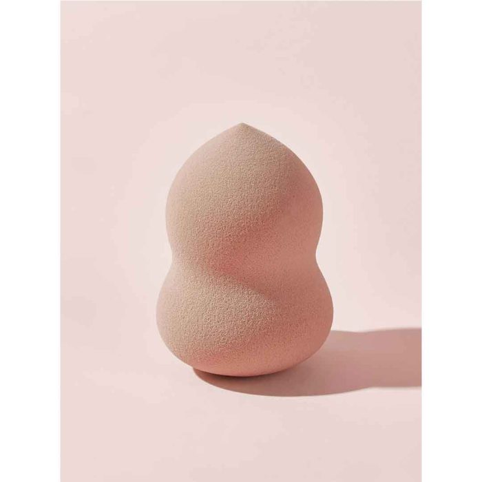 Extreme close up of single blender pink from Sheglam 6 piece set very soft porous flexible sponge texture for optimal foundation absorption velvety surface Sheglam
